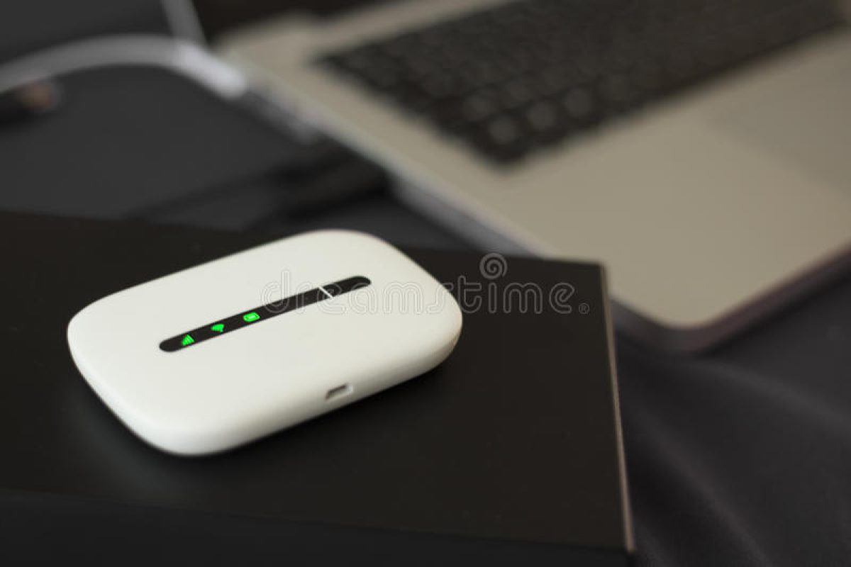 g-mini-wifi-router-external-hard-drive-case-next-to-laptop-54512428